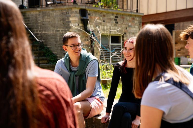 Students chatting and relaxing outside
