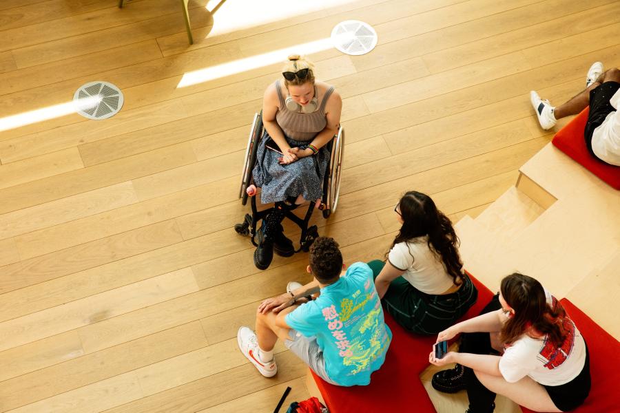 Students talking in West Hub, seen from above